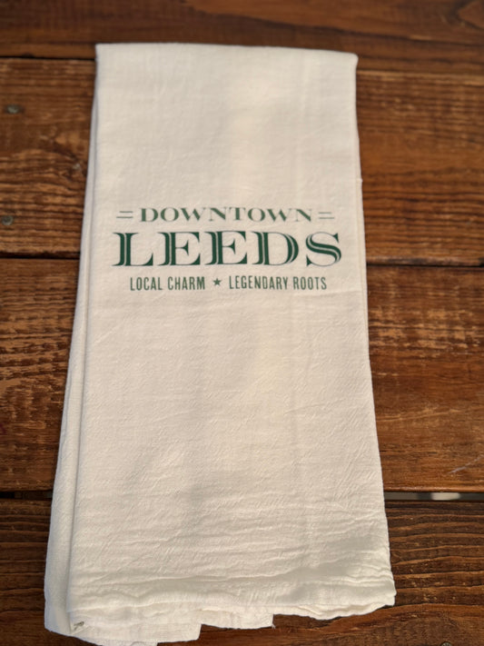 White towel with 'Downtown Leeds' text on a wooden surface
