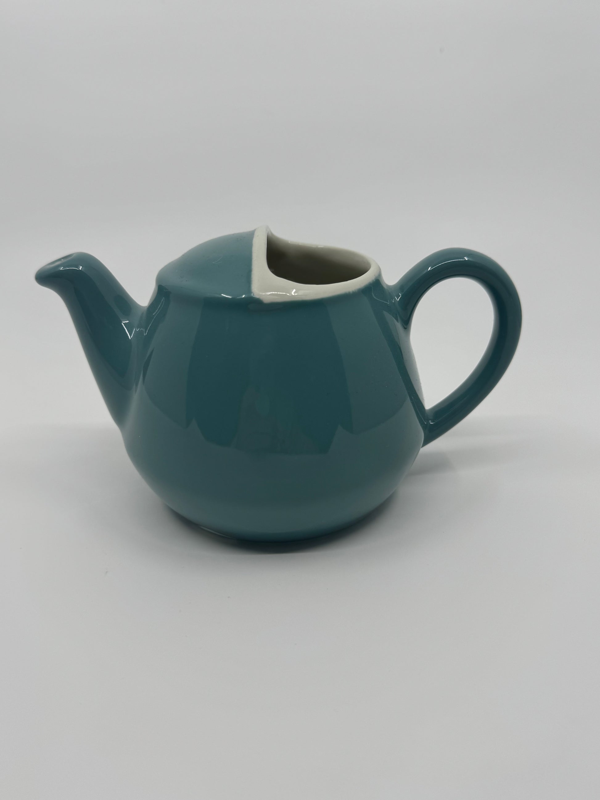 Teal teapot on a white background