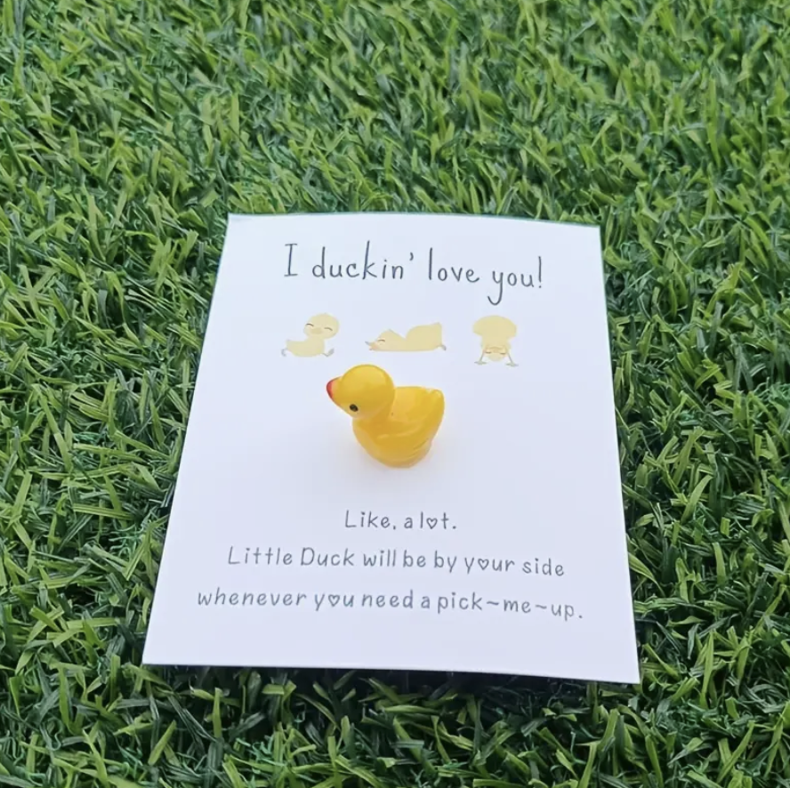 Yellow duck pocket hug with the message: I duckin' love you! like, a lot. little duck will be by your side whenever you need a pick-me-up.