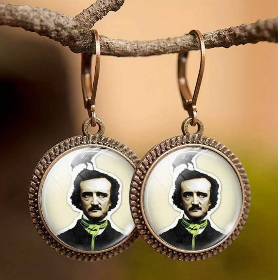 Earrings with circular pendant featuring a portrait on a branch against a blurred background