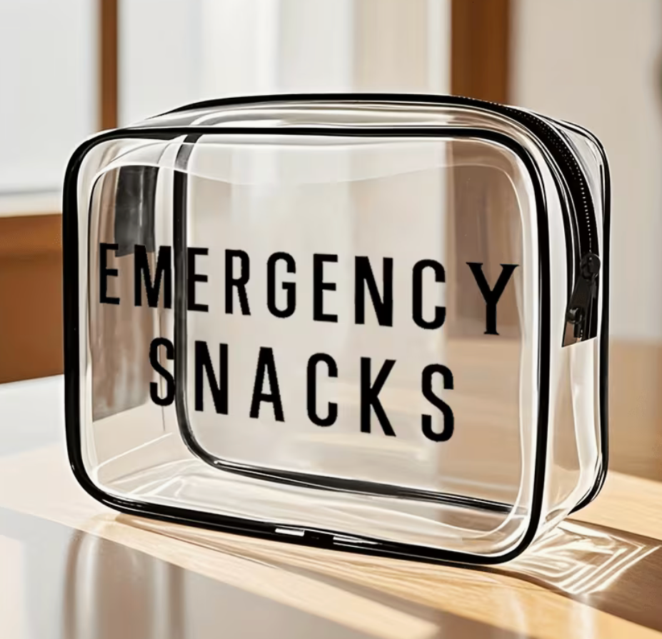 Clear Emergency Snacks zipper bag with black lettering and black trim