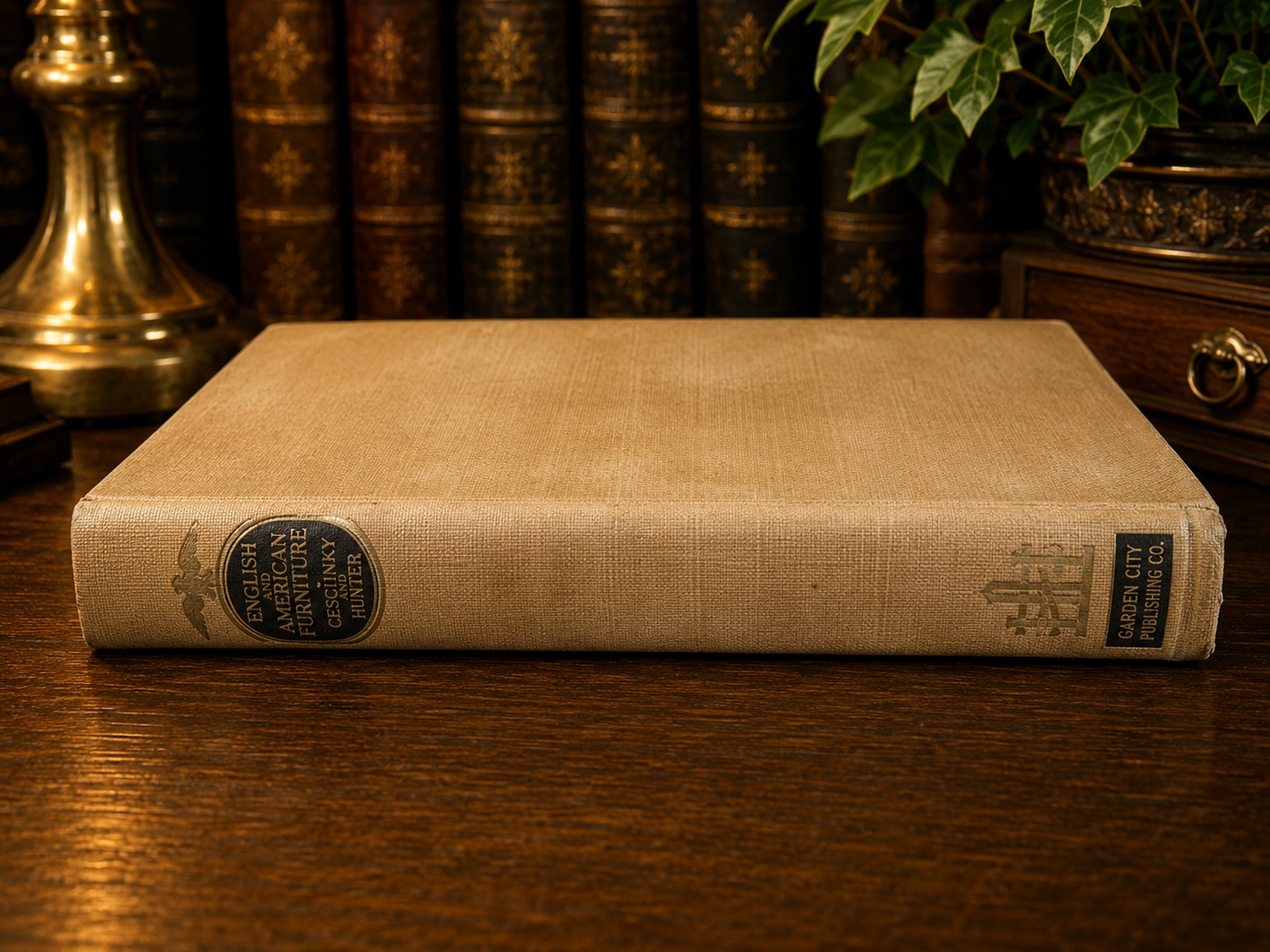 Vintage book with a cloth cover on a wooden surface, surrounded by other books and a plant.