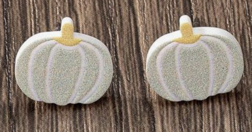 Pair of pumpkin-shaped earrings on a wooden background