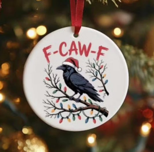 Acrylic ornament featuring a crow in a Santa hat with Christmas lights and the phrase F-Caw-F.