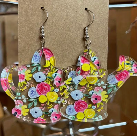 Colorful floral acrylic watering can dangle earrings with bright flower design displayed on an earring card