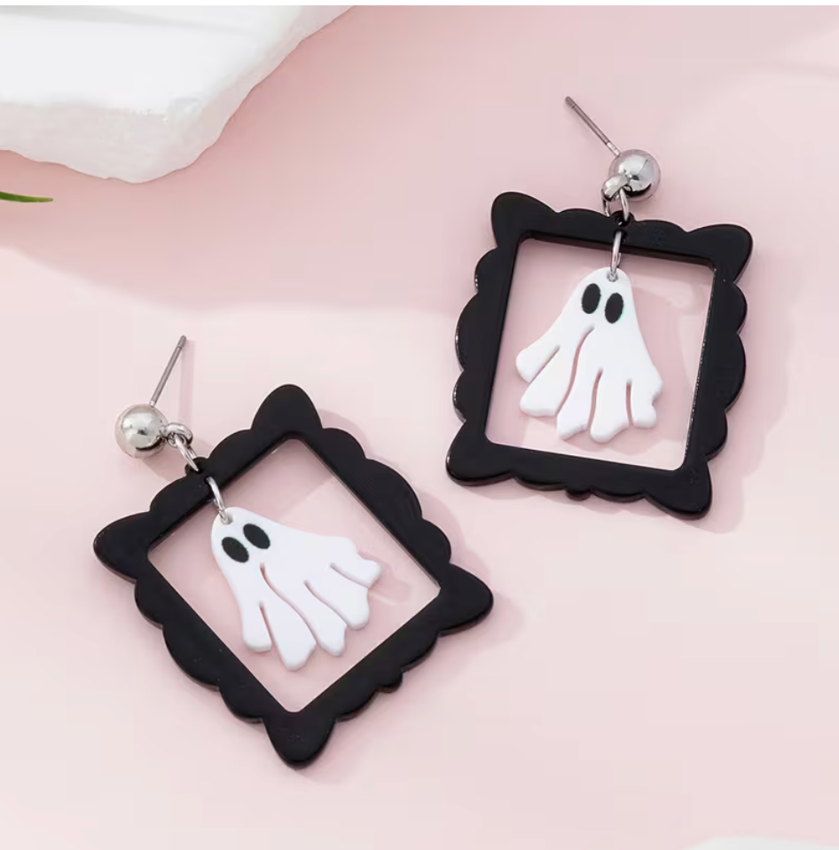 White ghost Halloween dangle earrings suspended inside decorative black frames with silver-tone studs.