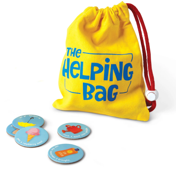 Yellow drawstring bag labeled 'The Helping Bag' with colorful cards on a white background
