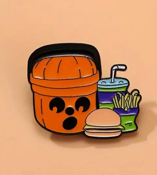 Halloween jack-o’-lantern enamel pin featuring a Coke, hamburger, and fries inspired by the classic McDonald’s Happy Meal bucket