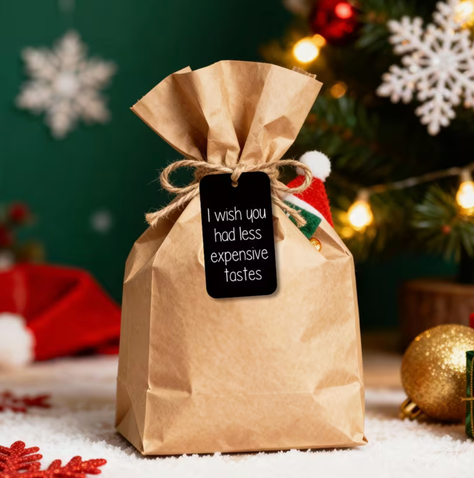 Assorted sarcastic Christmas gift tags displayed with wrapped holiday gifts