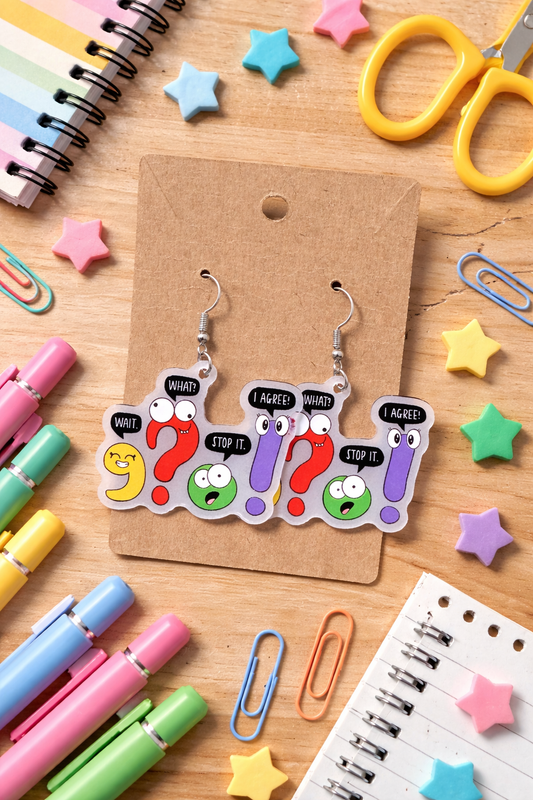 Colorful grammar punctuation dangle earrings featuring cartoon question marks and exclamation points with speech bubbles displayed on a kraft card.