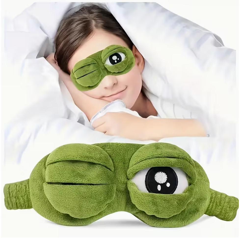 Funny green frog plush sleep mask with stretchy band and 3D sleepy eyes shown being worn for sleeping.