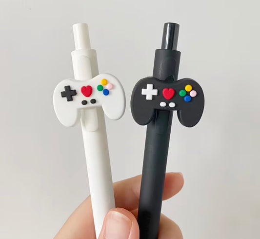 Black and white novelty ballpoint pens featuring video game controller toppers for gamers, classroom rewards, and party favors.