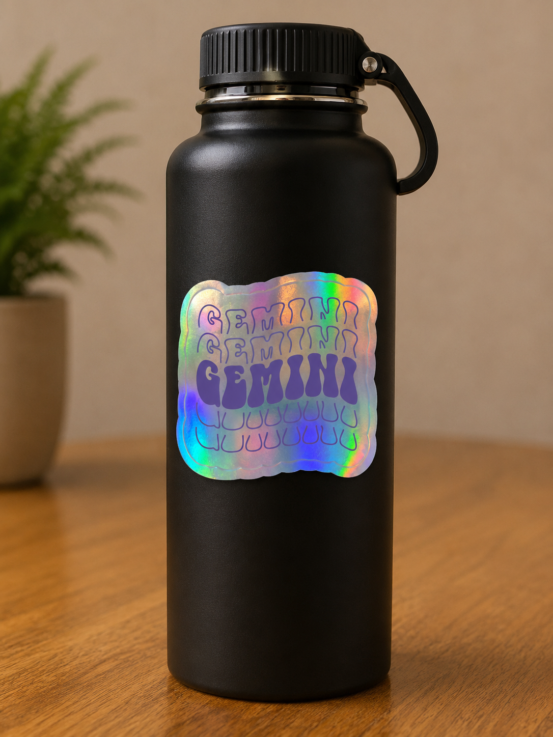 Holographic Gemini zodiac vinyl sticker displayed on a black insulated water bottle, astrology-inspired die cut sticker.