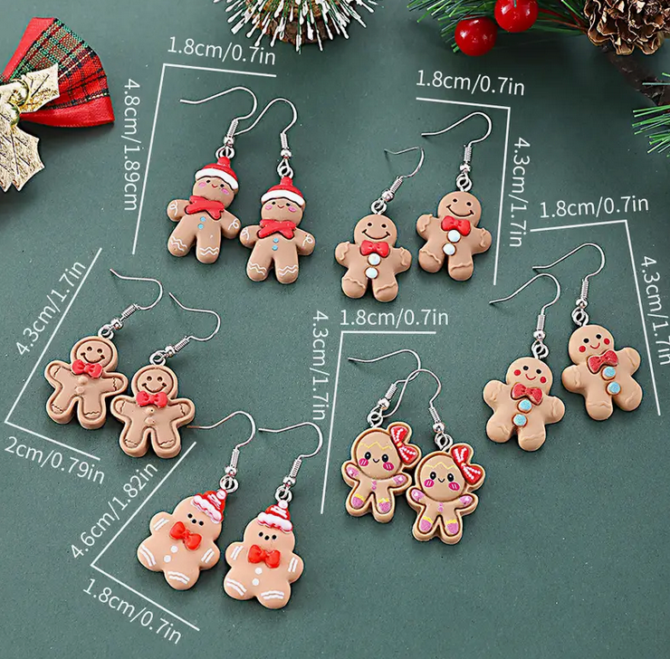 Gingerbread-themed earrings with measurements on a green background