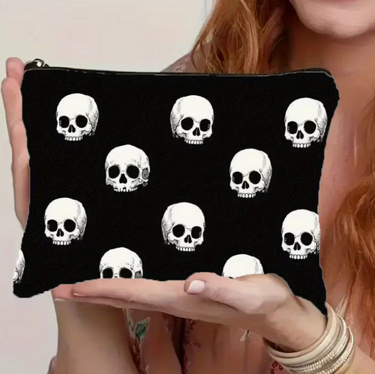 black gothic zipper pouch featuring an all-over white skull print displayed in hands against a neutral background