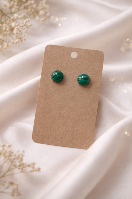 Green ball stud earrings displayed on a neutral card with a soft light background