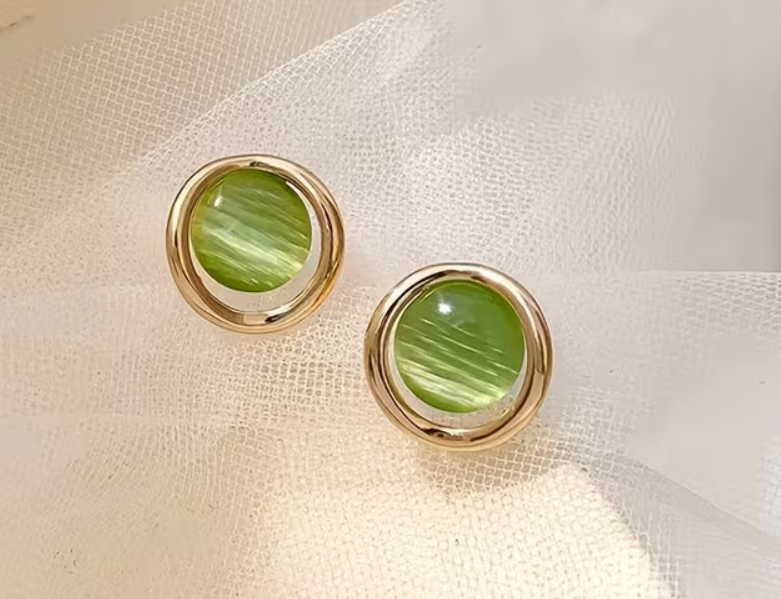 Round green cat eye stud earrings with glossy striped green centers and polished gold-tone circular frames, measuring approximately 0.55 inches