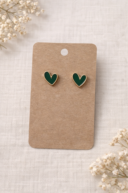Green heart stud earrings with gold tone outline displayed on a neutral card with a soft background