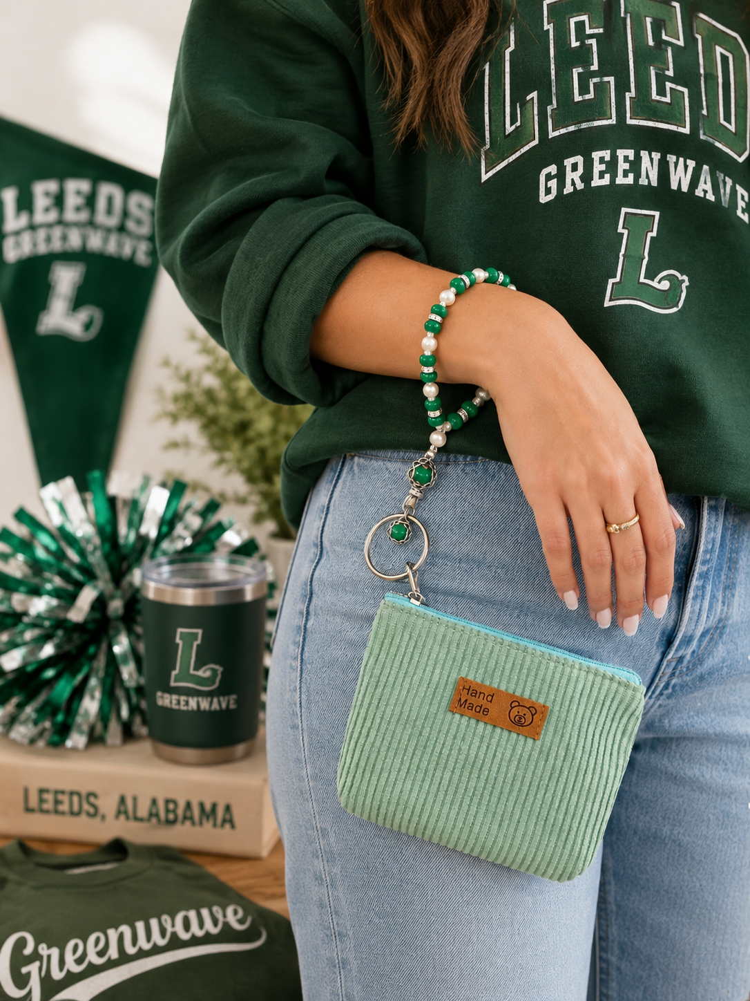 Green and white beaded wristlet keychain with mint pouch styled with green school spirit accessories