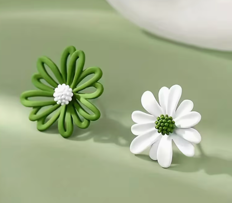 Green and white daisy stud earrings with floral design on soft background