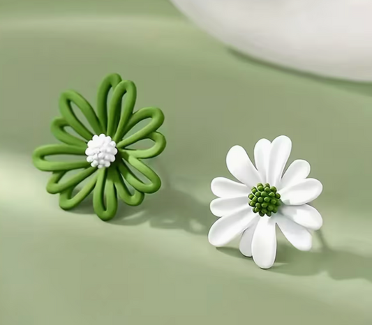 Green and white daisy stud earrings with floral design on soft background
