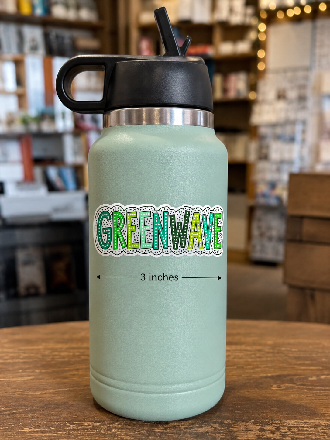 Greenwave 3 inch vinyl school spirit sticker displayed on a mint green water bottle