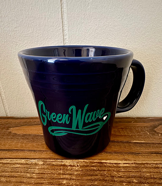 Navy blue mug with 'Green Wave' text on a wooden surface