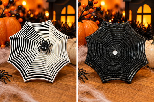 Two Halloween spiderweb fidget toy designs displayed side by side, featuring a black and white layered spiderweb with a spider in the center and a black glitter spiderweb.