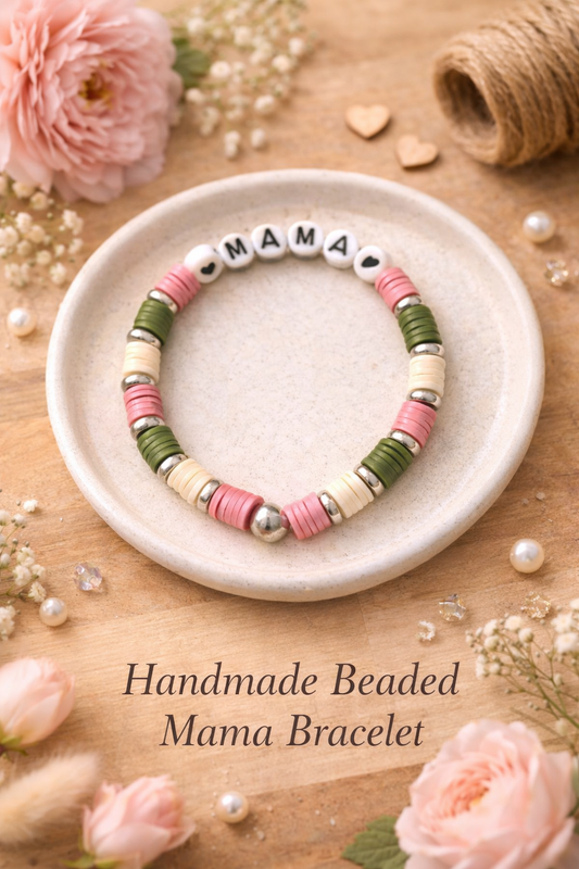 Handmade beaded 'Mama' bracelet on a wooden surface with flowers and twine.
