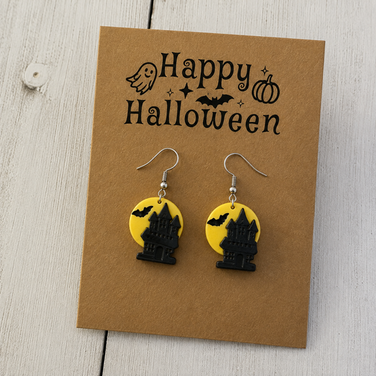 Black haunted house and bat resin dangle earrings with yellow full moon design for Halloween