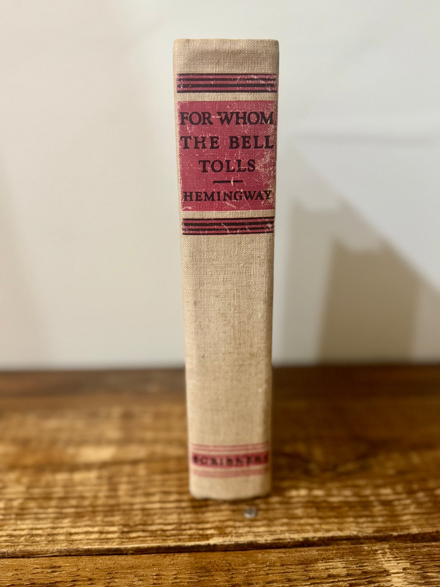 Cover of For Whom the Bell Tolls by Ernest Hemingway, 1940 vintage edition, featuring a classic design with bold typography and a landscape illustration.