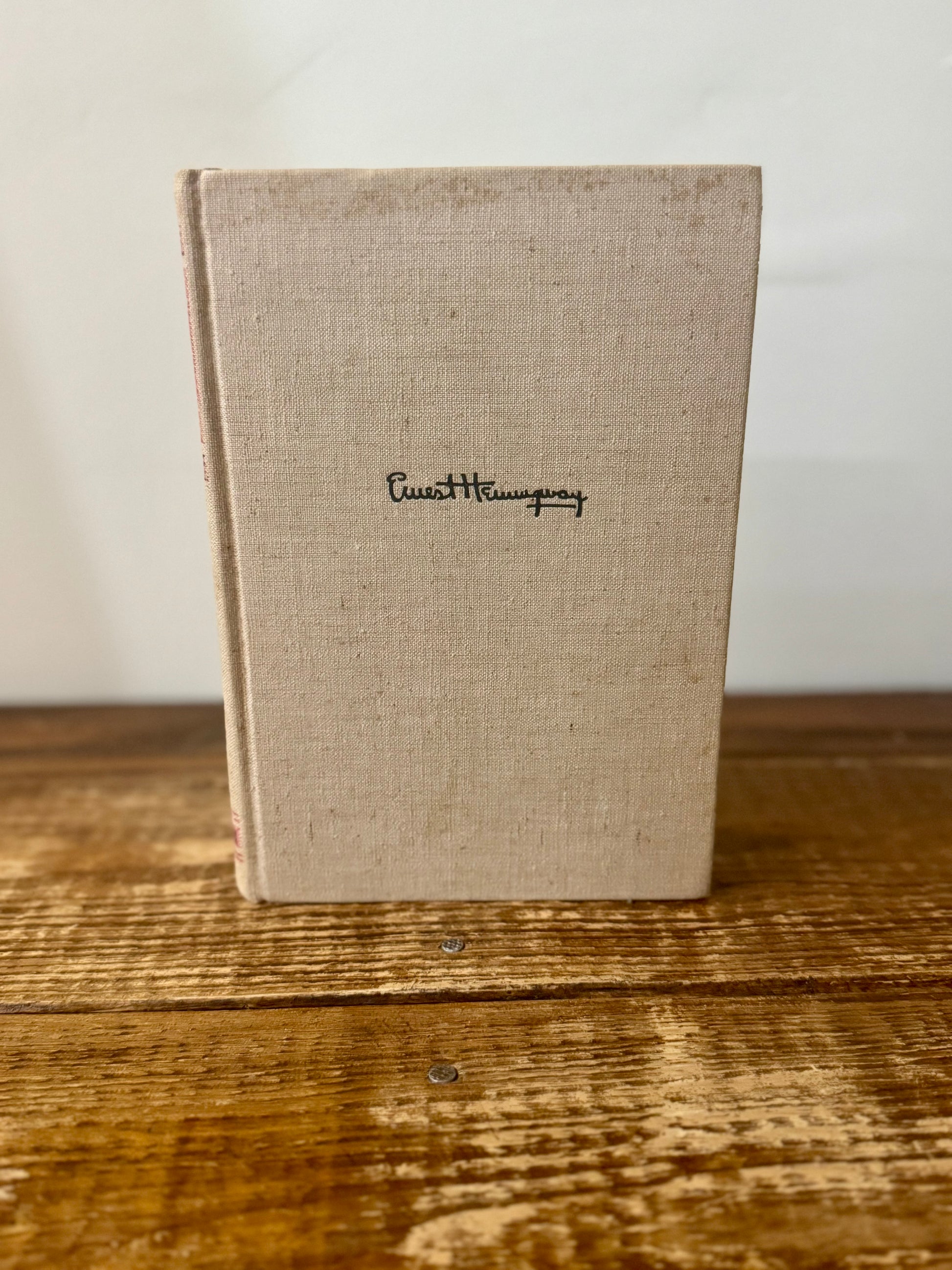 Cover of For Whom the Bell Tolls by Ernest Hemingway, 1940 vintage edition, featuring a classic design with bold typography and a landscape illustration.