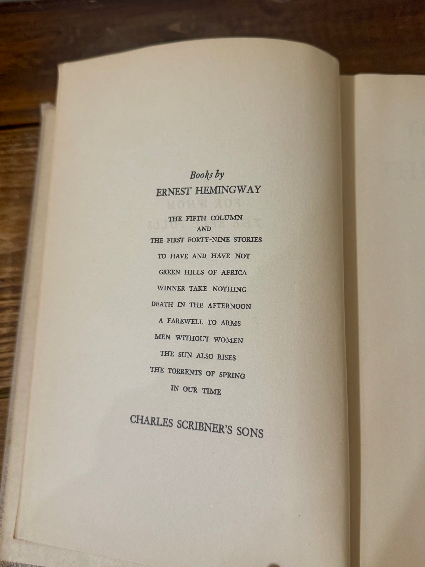 Cover of For Whom the Bell Tolls by Ernest Hemingway, 1940 vintage edition, featuring a classic design with bold typography and a landscape illustration.