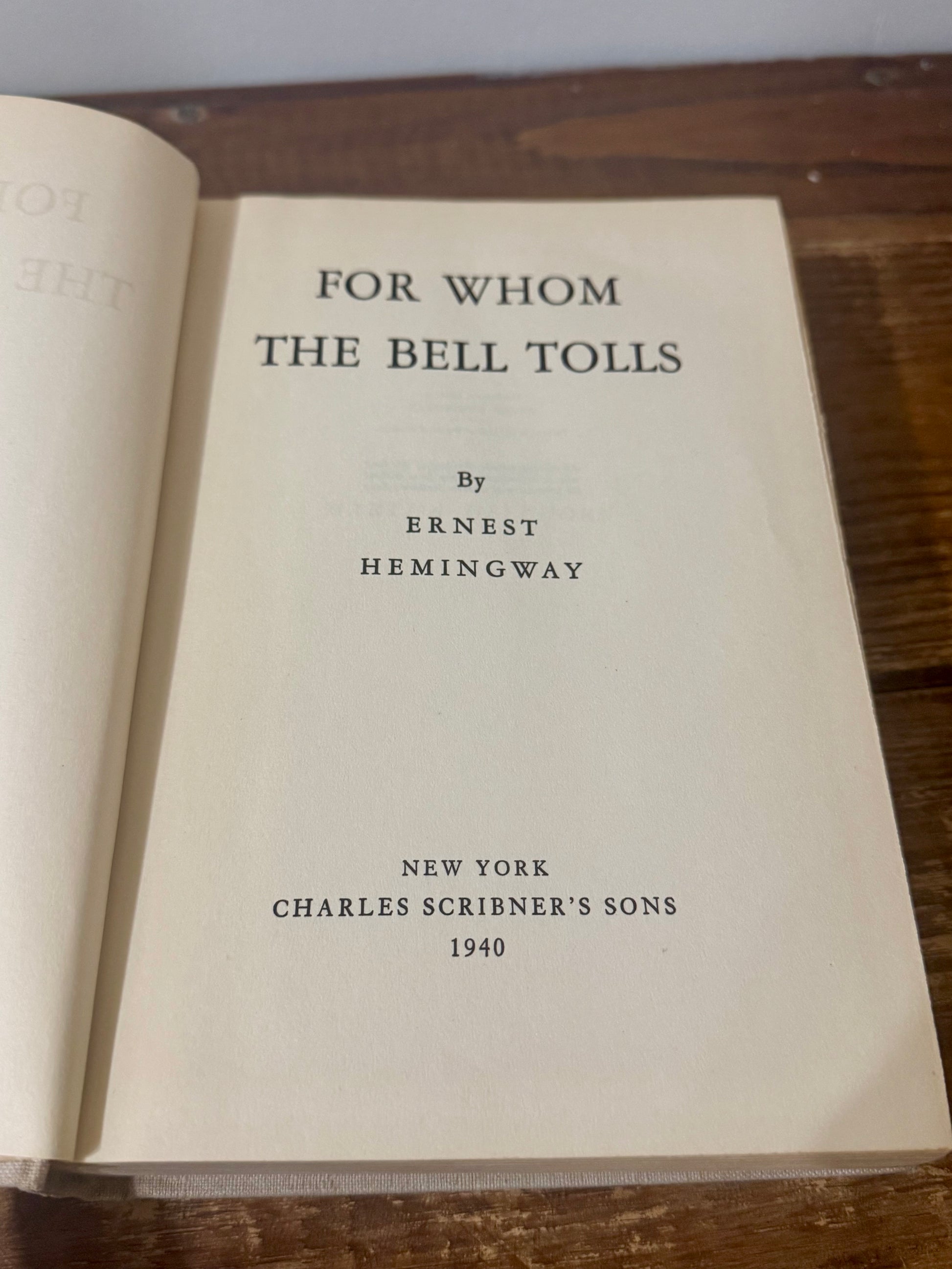 Cover of For Whom the Bell Tolls by Ernest Hemingway, 1940 vintage edition, featuring a classic design with bold typography and a landscape illustration.