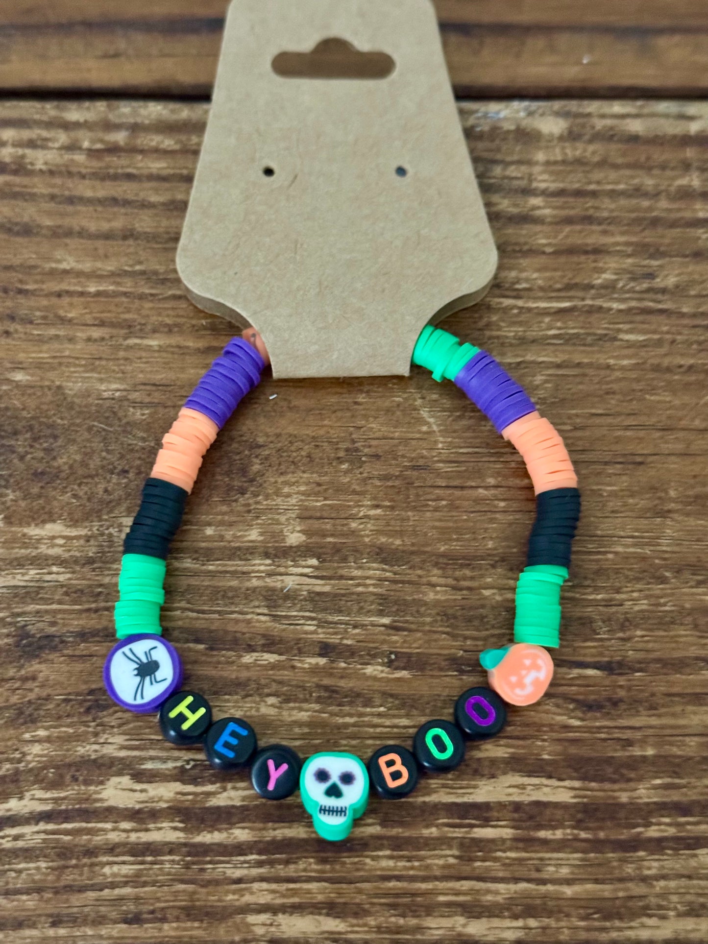 Colorful beaded bracelet with Halloween-themed beads on a wooden surface