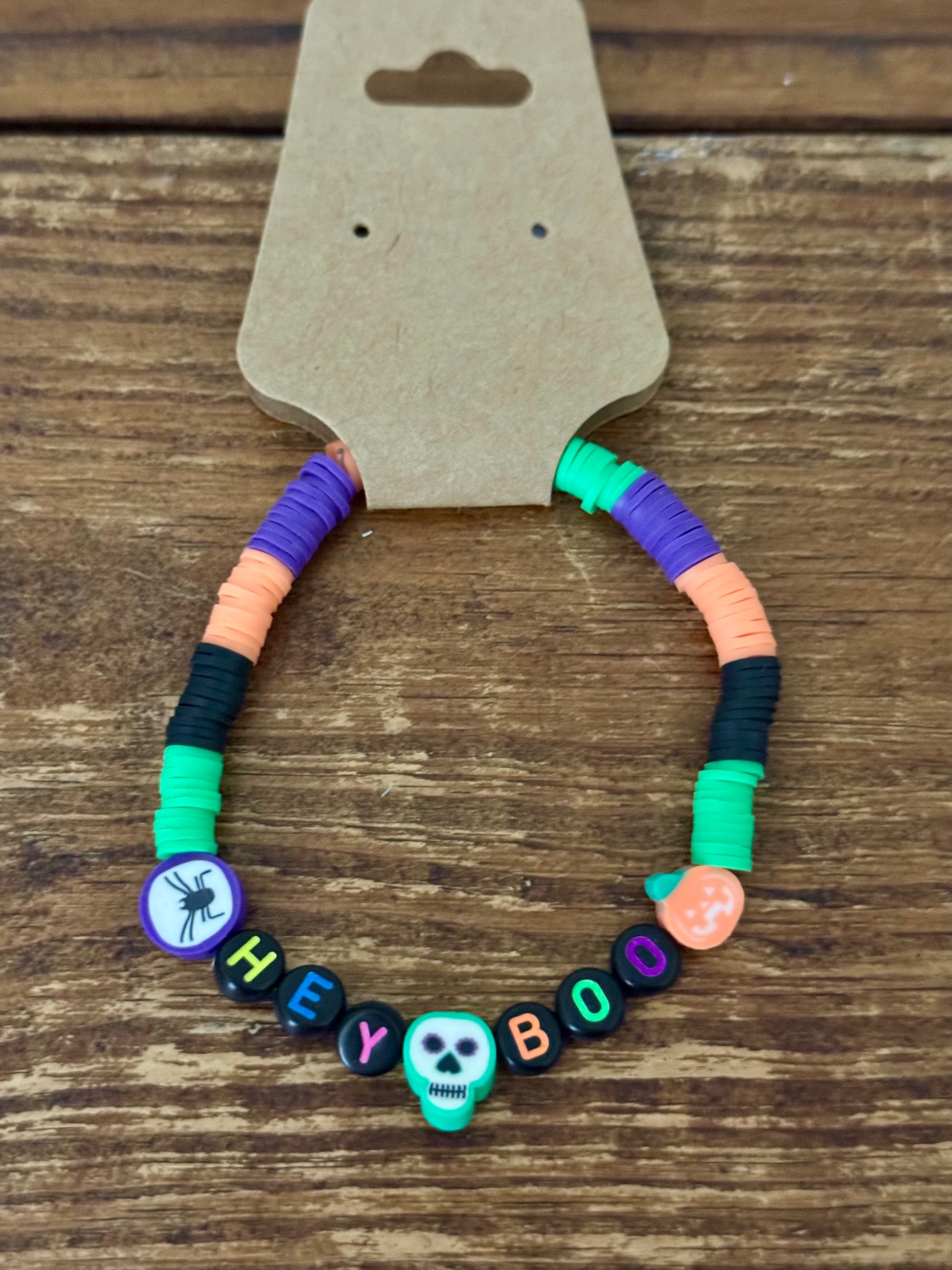 Colorful beaded bracelet with Halloween-themed beads on a wooden surface