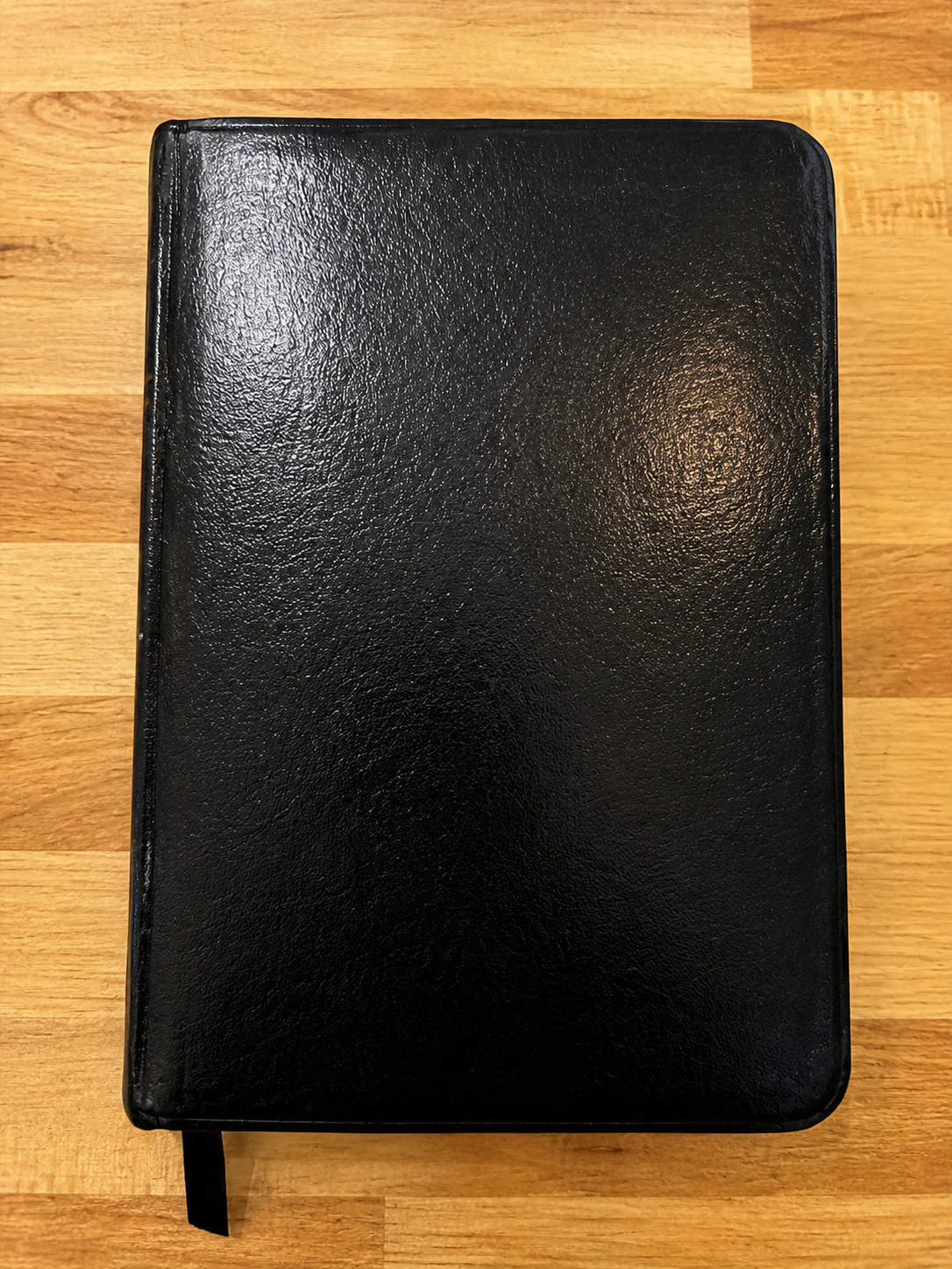 Black bonded leather Holy Bible in the New International Version, Pocket Size Classic Edition, with ribbon marker.