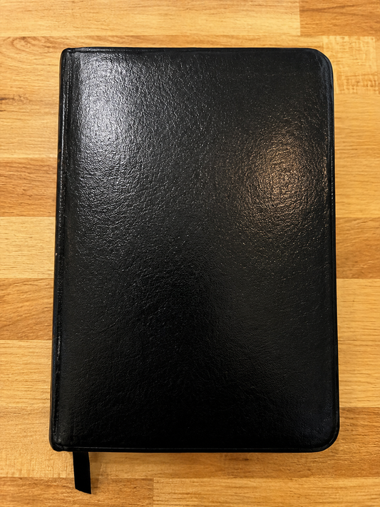 Black bonded leather Holy Bible in the New International Version, Pocket Size Classic Edition, with ribbon marker.