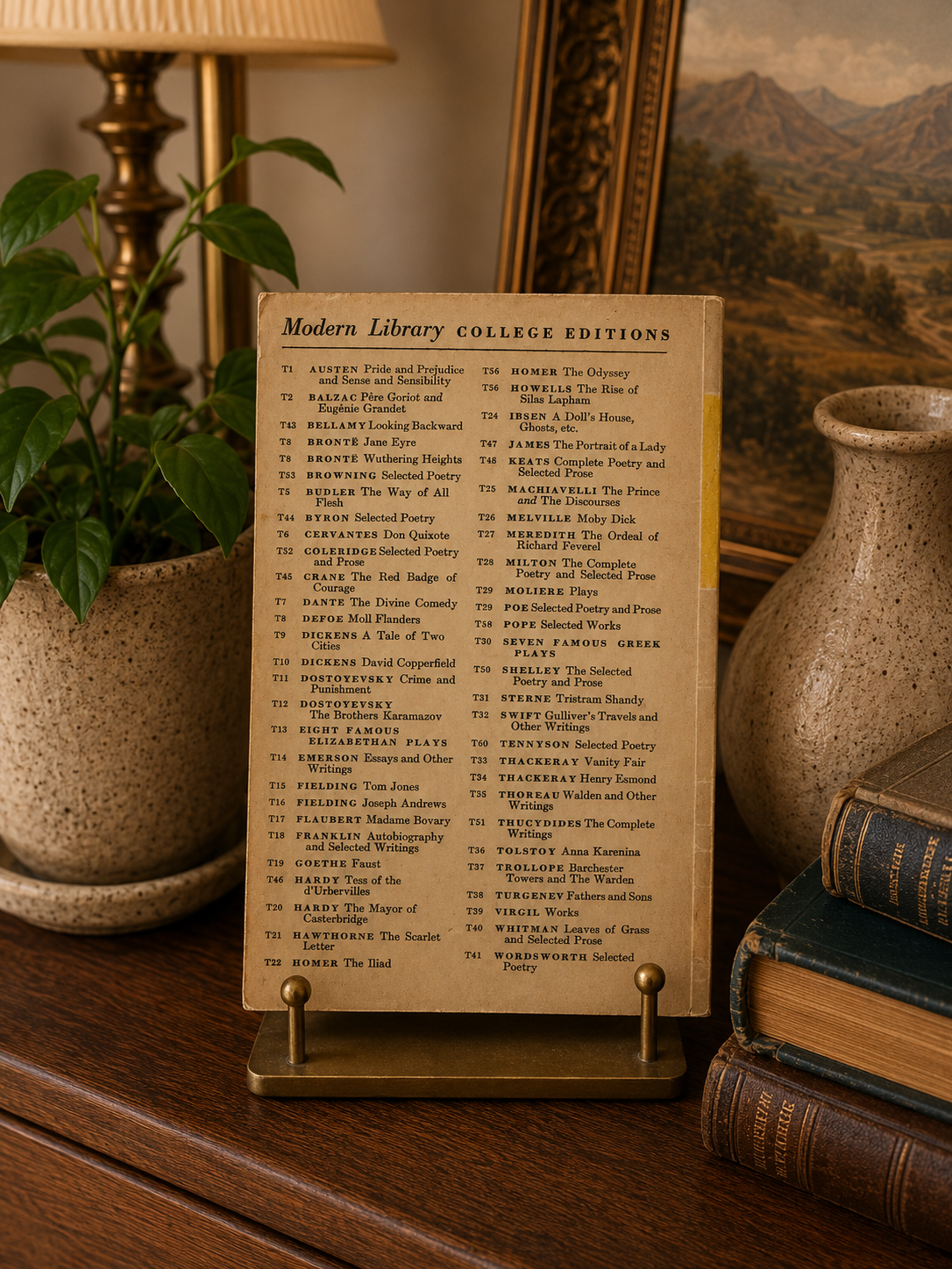 Sheet of paper with text on a stand in a decorative setting with books and a lamp.