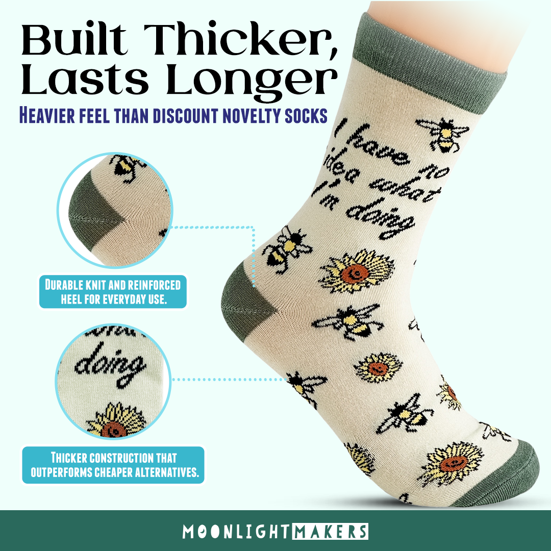Promotional graphic of I have no idea what I’m doing novelty crew socks with bee and sunflower design in soft yellow and green, showing close-up callouts of reinforced heel and thicker knit construction with Built Thicker, Lasts Longer text and Moonlight Makers branding.