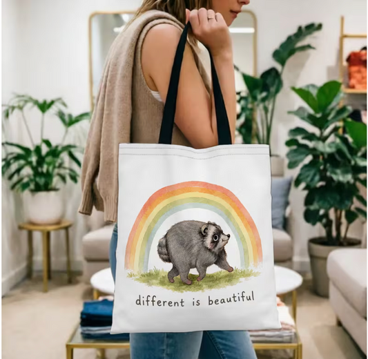 Jimothy the Raccoon Different Is Beautiful rainbow tote bag carried over the shoulder