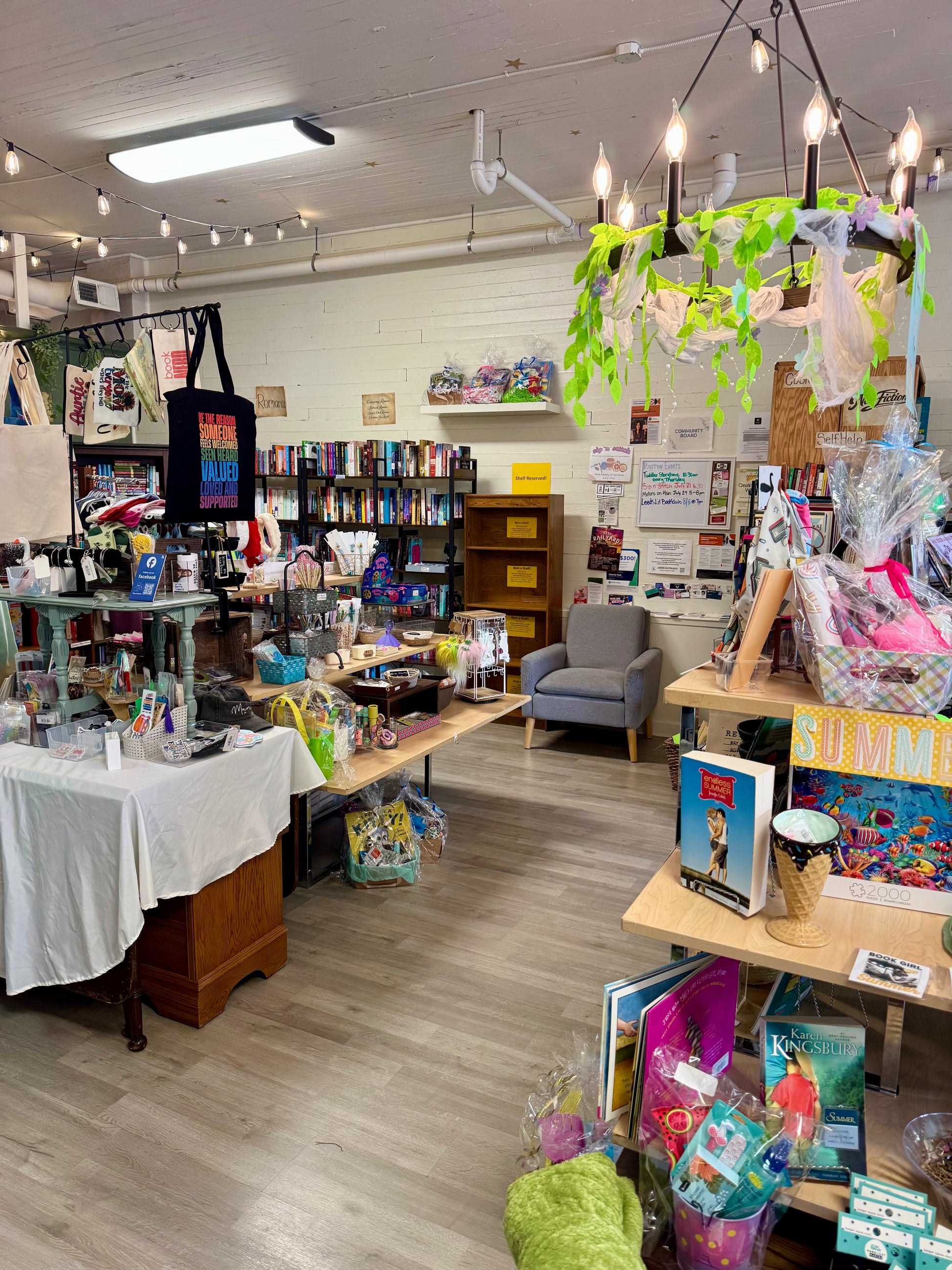 Wide view of independent bookstore showing vendor shelf rental display among books and locally made gifts.