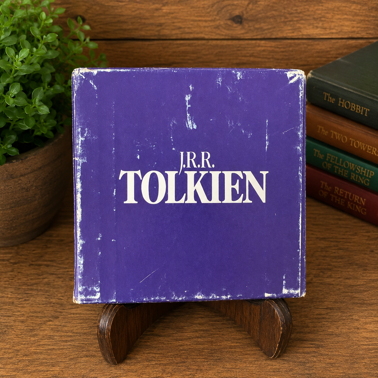 Bottom of the original purple Del Rey Fantasy slipcase for the vintage J.R.R. Tolkien The Hobbit and The Lord of the Rings four-book paperback boxed set. The bottom panel features the J.R.R. Tolkien logo and shows authentic fair-condition wear, including scuffed edges, rubbed corners, surface scratches, and shelf wear from years of use.
