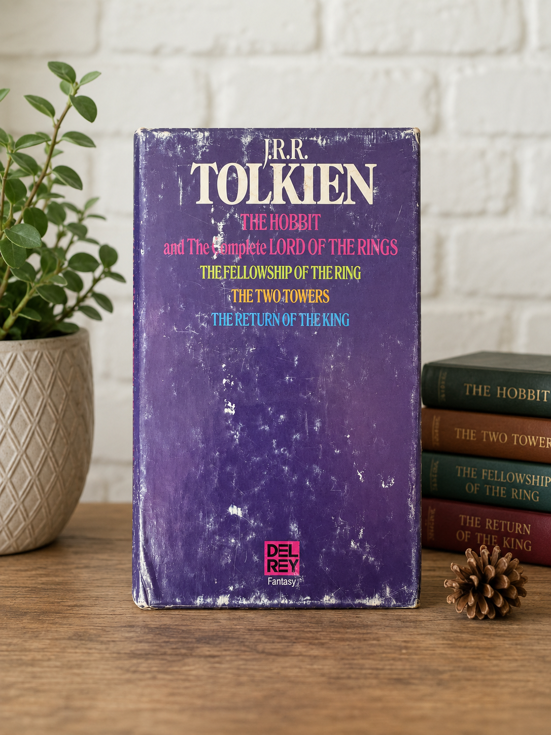 Front of the original Del Rey Fantasy slipcase for the vintage J.R.R. Tolkien The Hobbit and The Lord of the Rings four-book paperback boxed set. Purple slipcase displays authentic fair-condition wear including scuffing, rubbed edges, corner wear, and surface scratches.