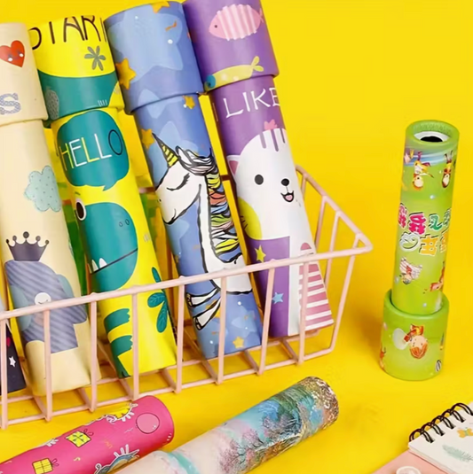 A colorful assortment of rotating kaleidoscopes with playful designs, displayed upright in a basket on a bright yellow background.