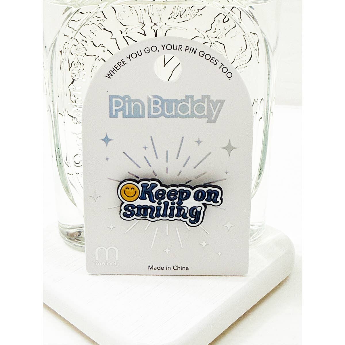 Keep on Smiling enamel pin with retro blue lettering and smiley face