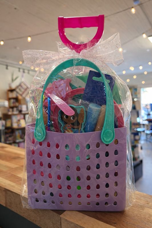 Kids summer gift basket with Doc McStuffins book and toys in pastel tote bag wrapped for gifting