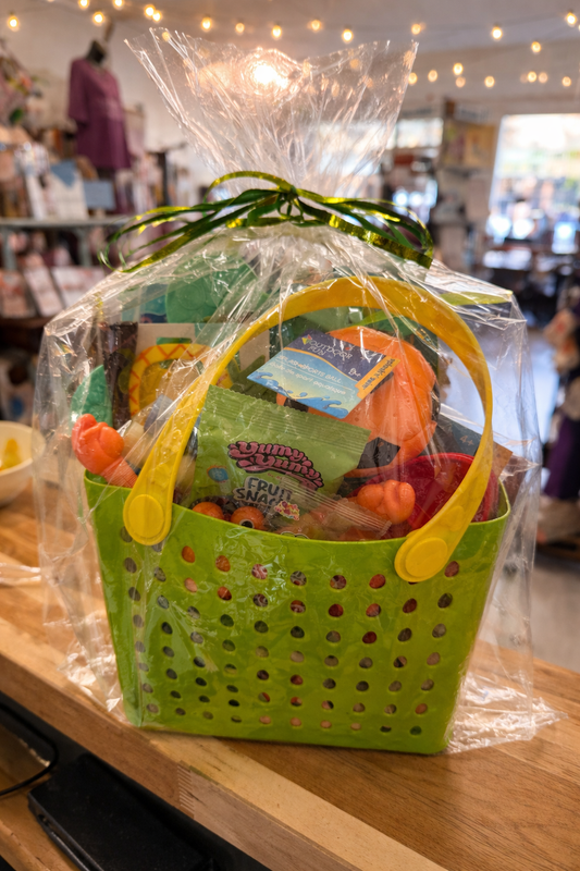 Kids summer gift basket with Peppa Pig Plays Soccer book and outdoor toys in green tote bag wrapped for gifting