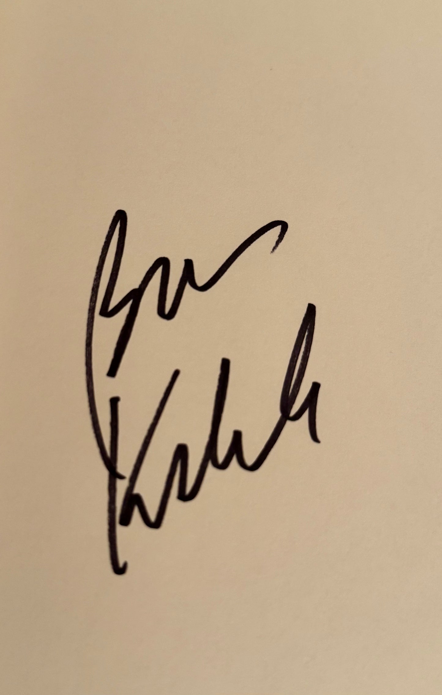 Signature on a beige background