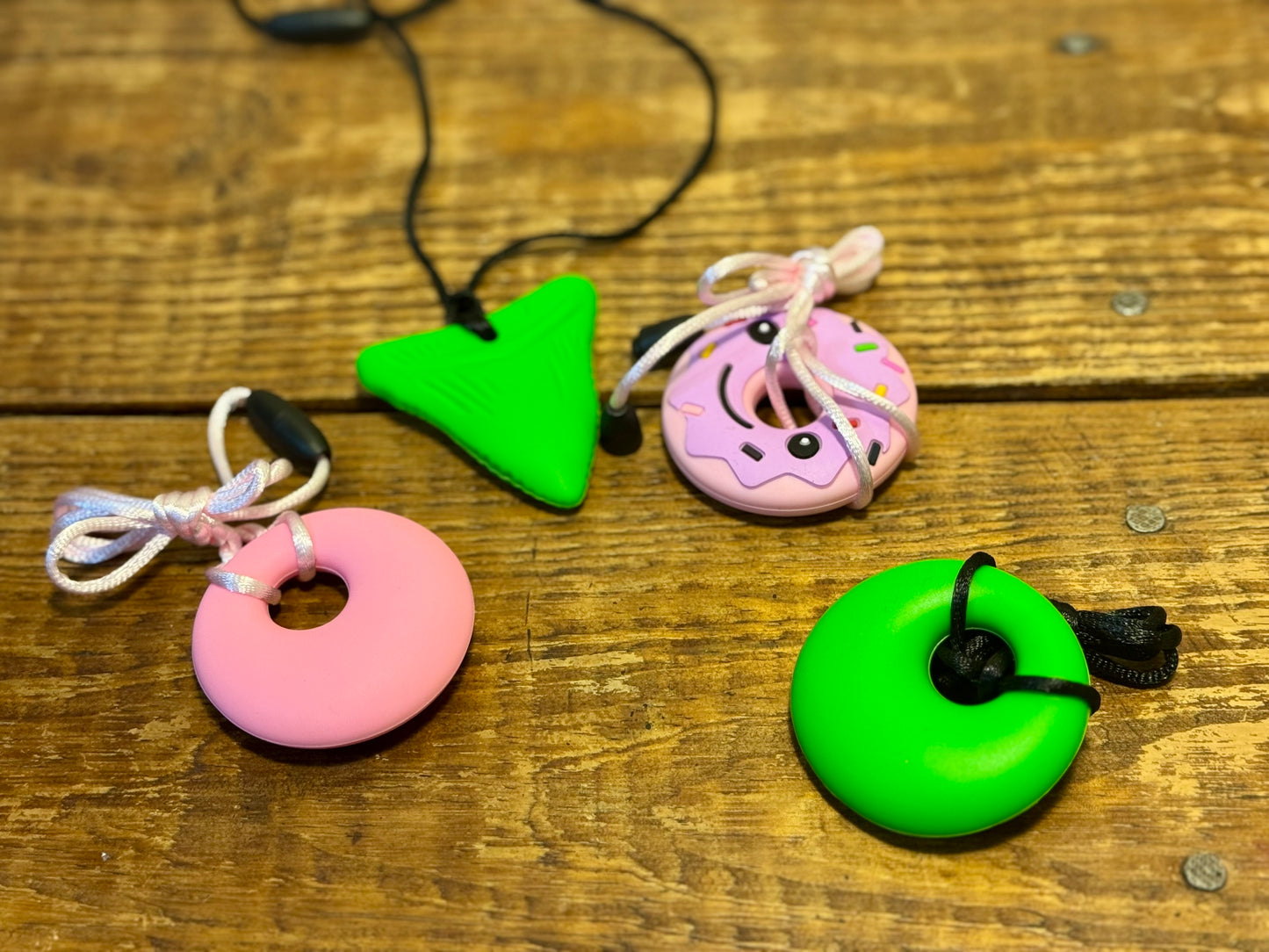 A colorful set of sensory chew necklaces in various shapes and designs, ideal for kids and adults needing oral sensory input.